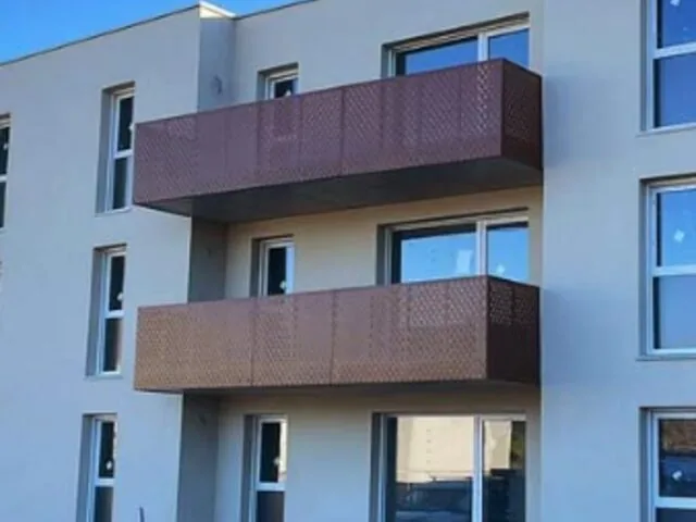 Garde-corps de balcons en tôle perforée corten sur façade d’immeuble